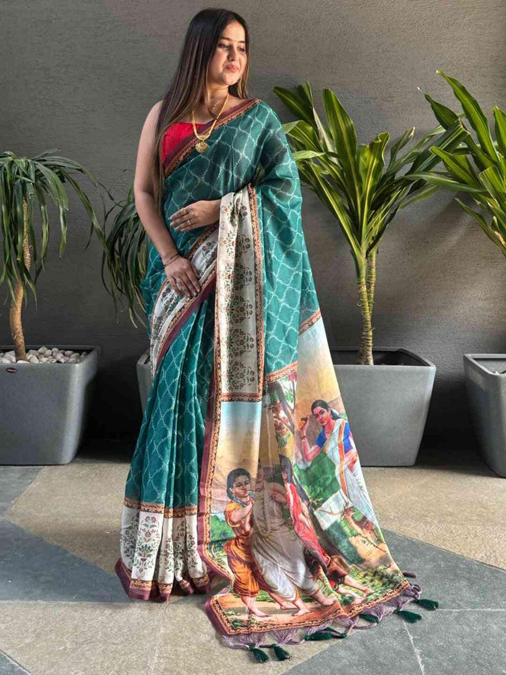 Teal Printed Silk Saree with Artistic Village Scene Pallu & Contrast Red Blouse Look
