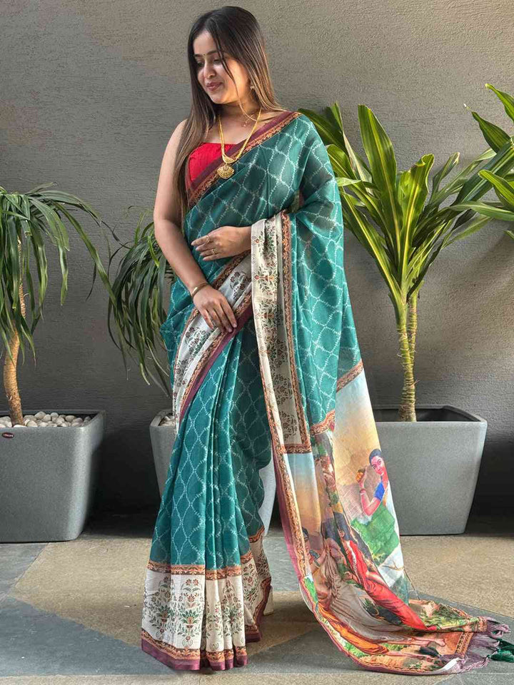 Teal Printed Silk Saree with Artistic Village Scene Pallu & Contrast Red Blouse Look