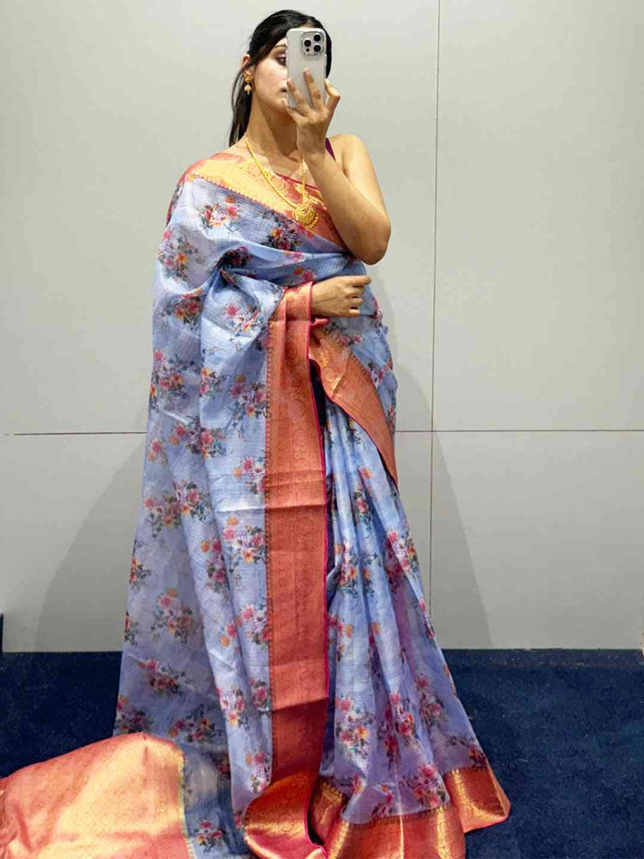 Pastel Blue Floral Silk Saree with Pink Gold Zari Border & Tassel Pallu