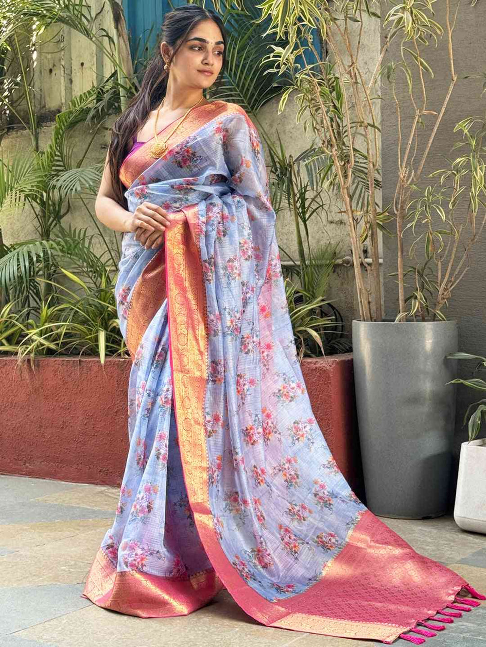 Pastel Blue Floral Silk Saree with Pink Gold Zari Border & Tassel Pallu