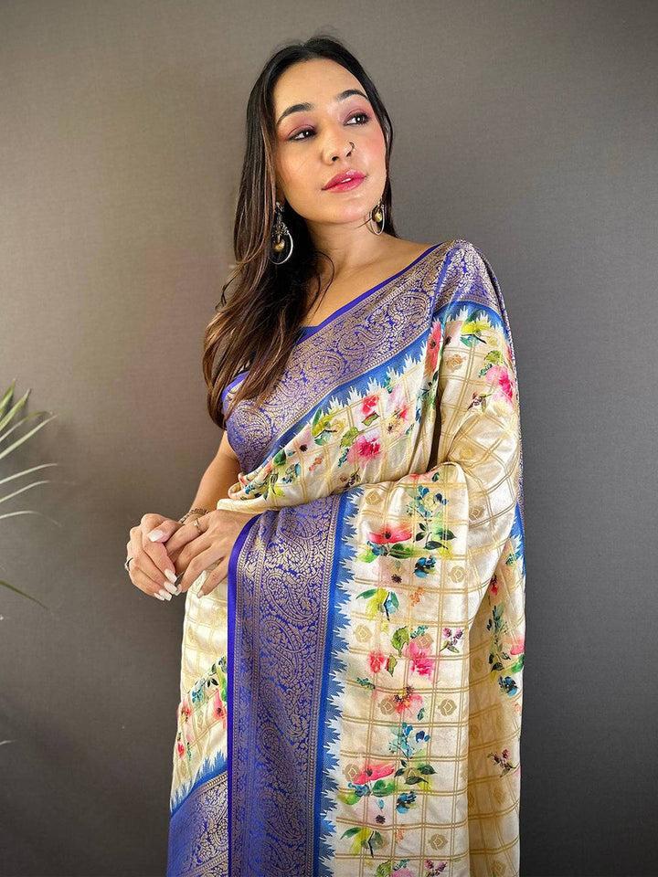 Cream Floral Banarasi Silk Saree with Royal Blue Zari Border & Tassel Pallu